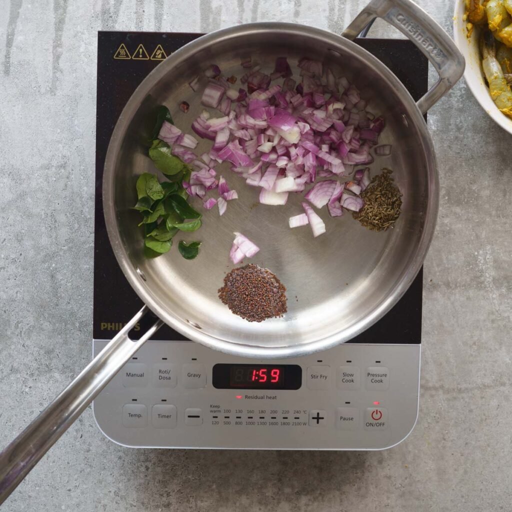 Pan with oil, onion,curry leaves, mustard and cumin