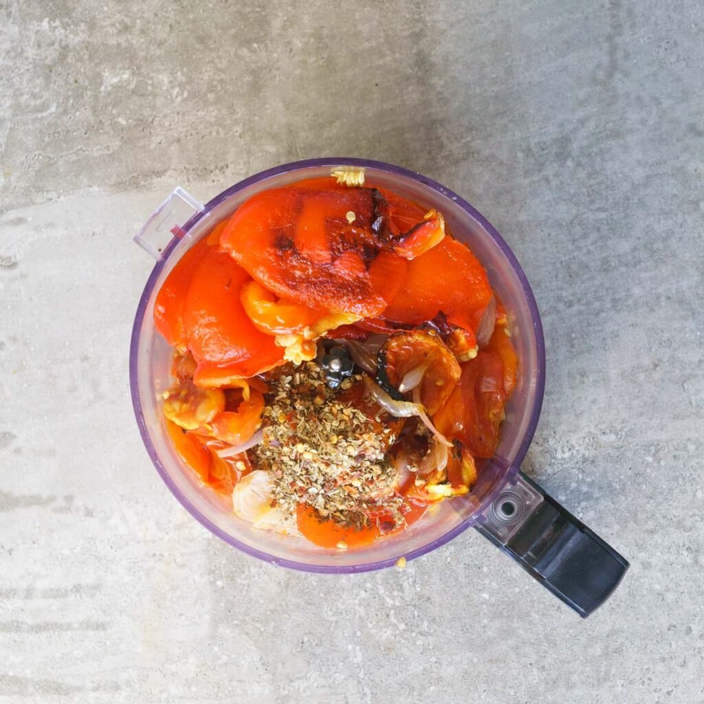 Roasted tomatoes, peppers, onions, garlic and herbs in a blender