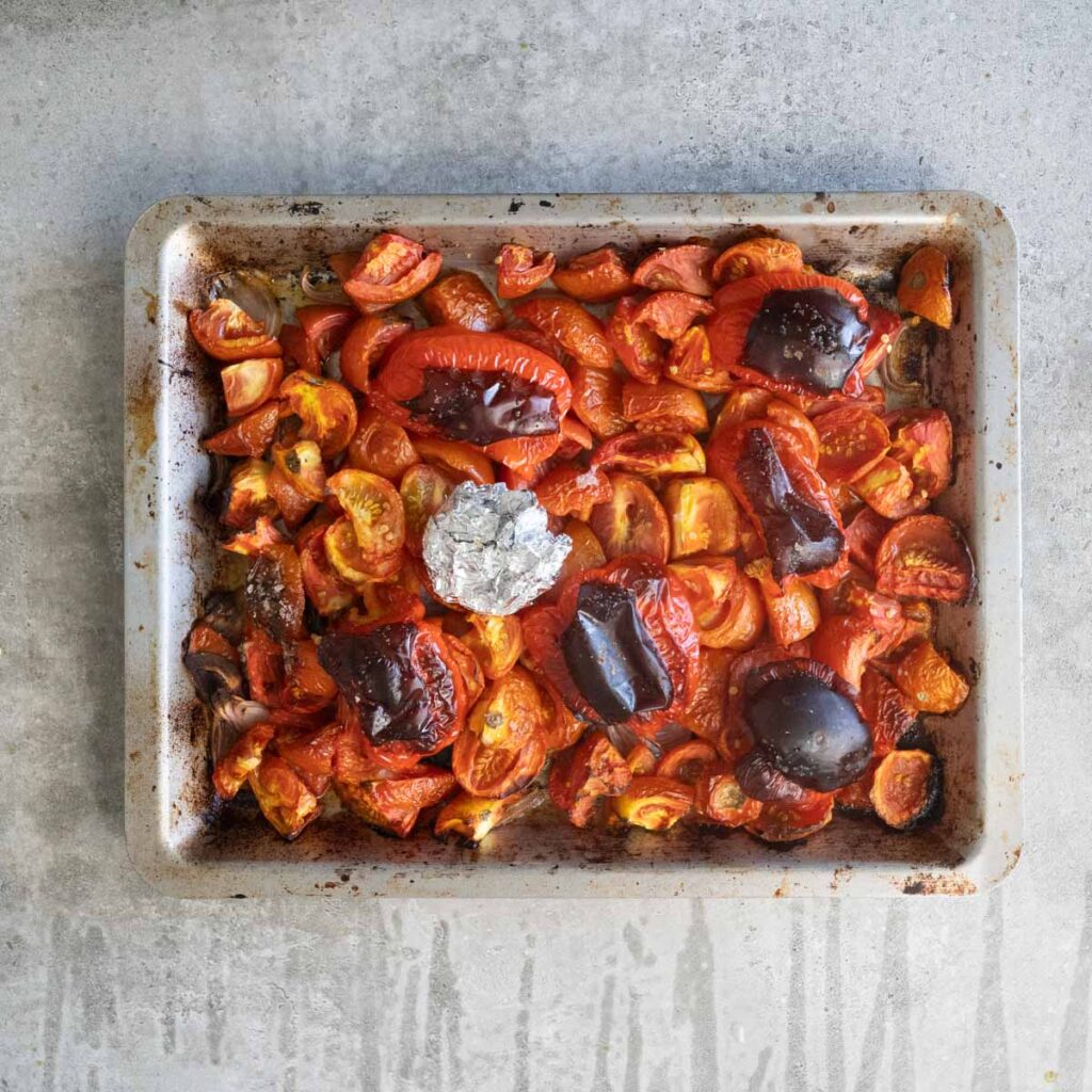 Roasted Tomatoes, red peppers and garlic in a baking tray
