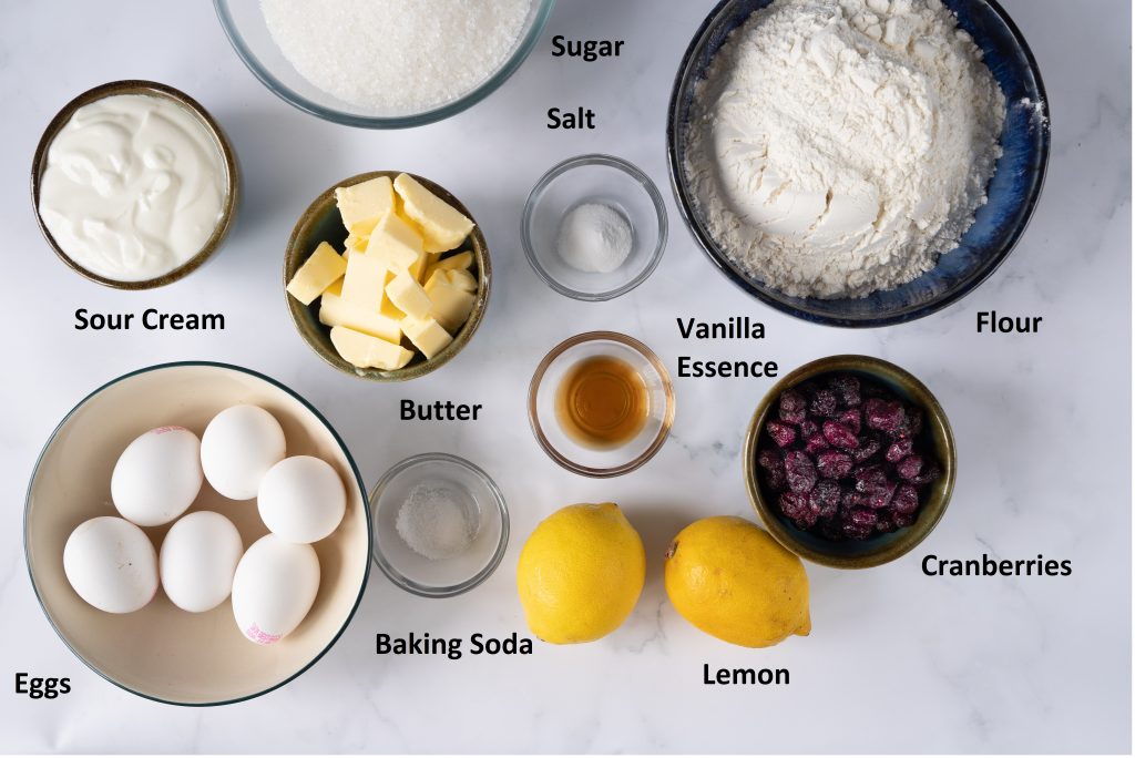 Ingredients for Lemon Cranberry Cake- Eggs,flour, dried cranberries, sugar,sour cream and lemon