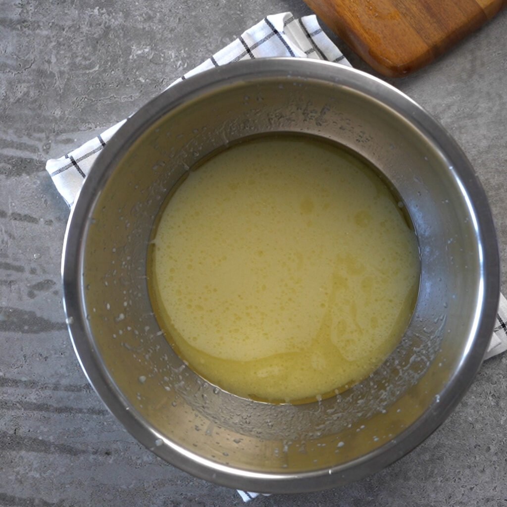 Making the eggless chocolate cake batter- Step 2 - Mixing the wet ingredients and sugar- Oil, Milk, vinegar and Sugar