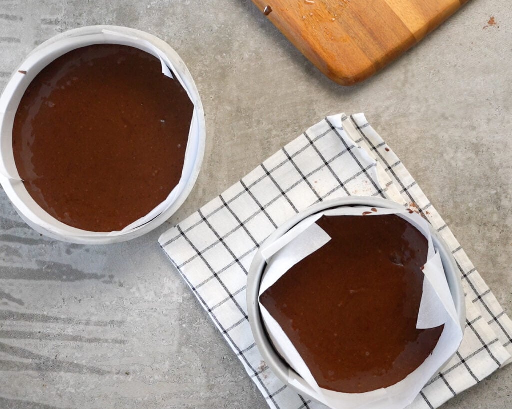 2 cake pans with the eggless chocolate cake batter to make a double decker cake.