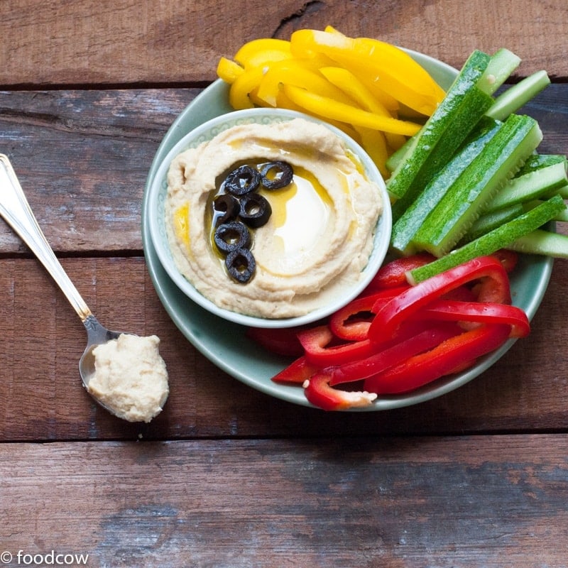 Hummus served with peppers, cucumber and olives