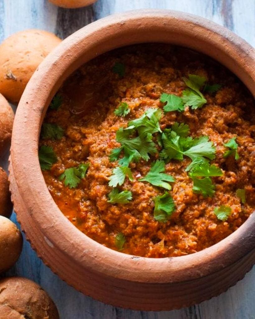 Indian Style chicken Keema or ground chicken in an earthen pot with lots of cilantro