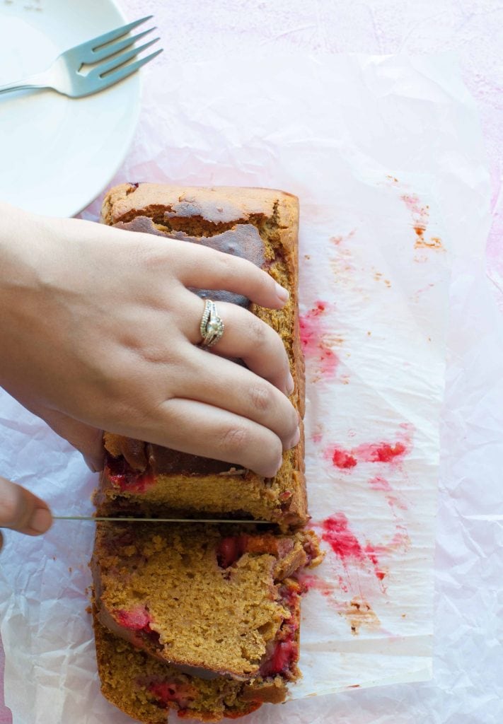 Healthy Whole Wheat strawberry cake being cut by a knife.