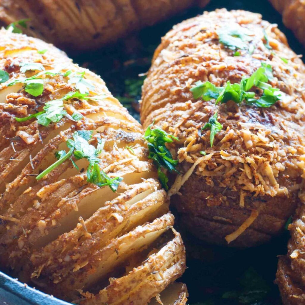 Close up or crispy hasselback potatoes with garlic and parmesan