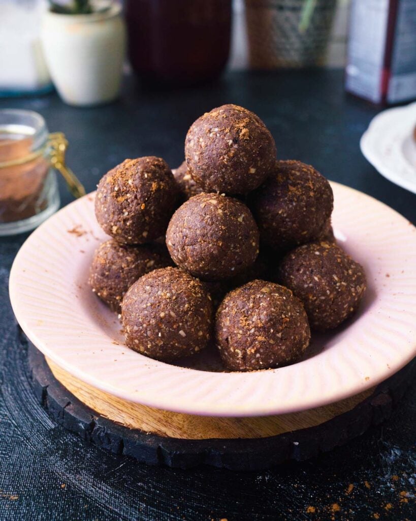 Chocolate Date Protein Energy Bliss Ball in a pink shallow bowl