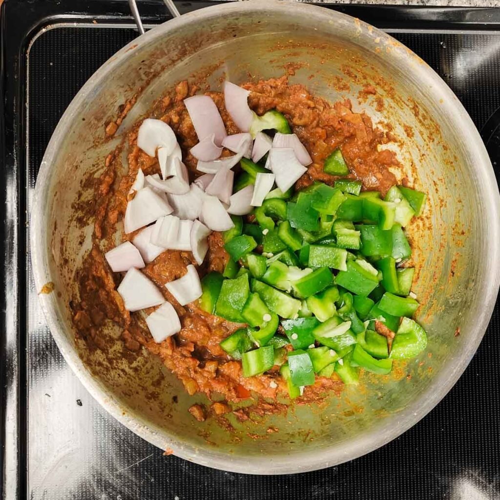 onions and capsicum in a pan