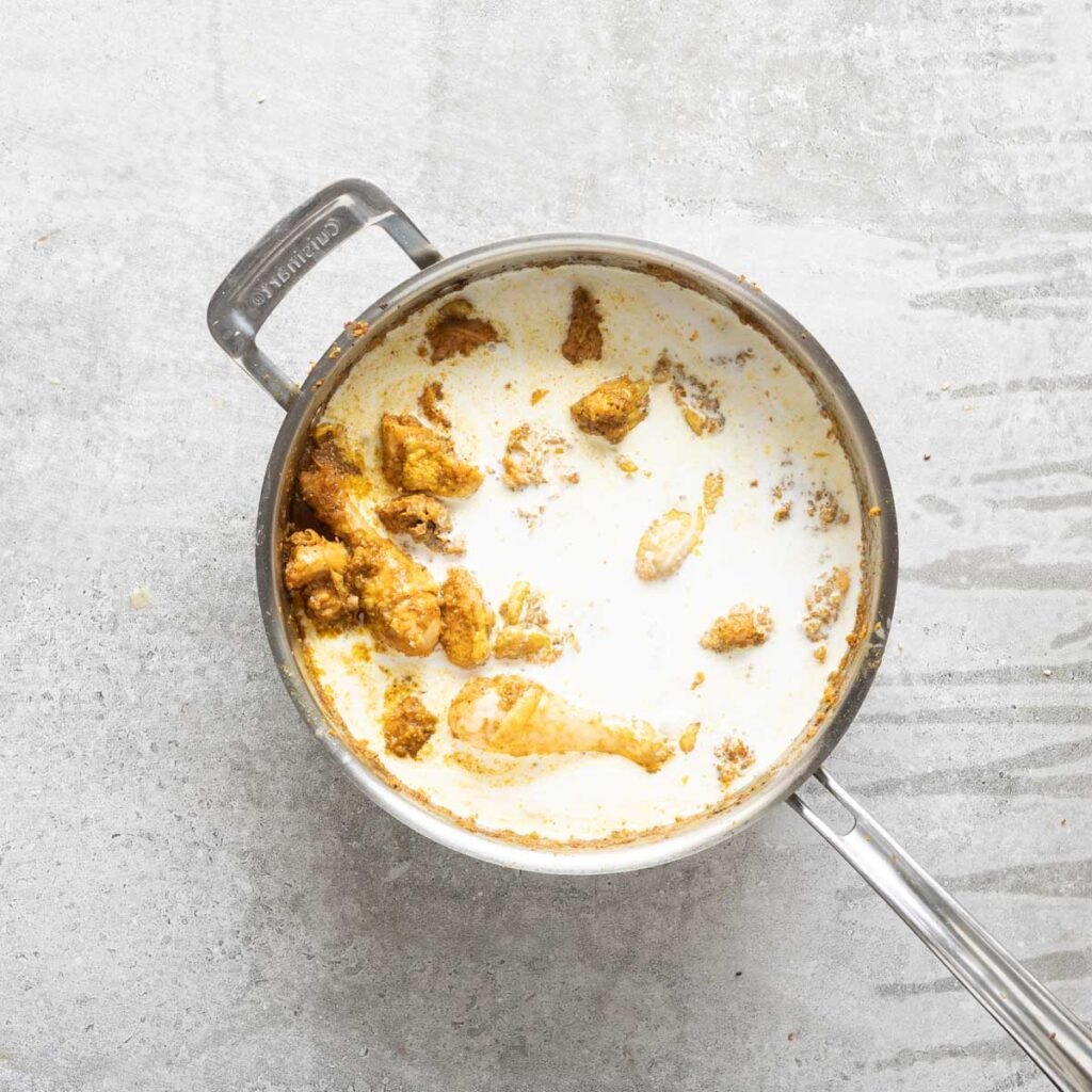 Coconut milk in a pan with chicken curry