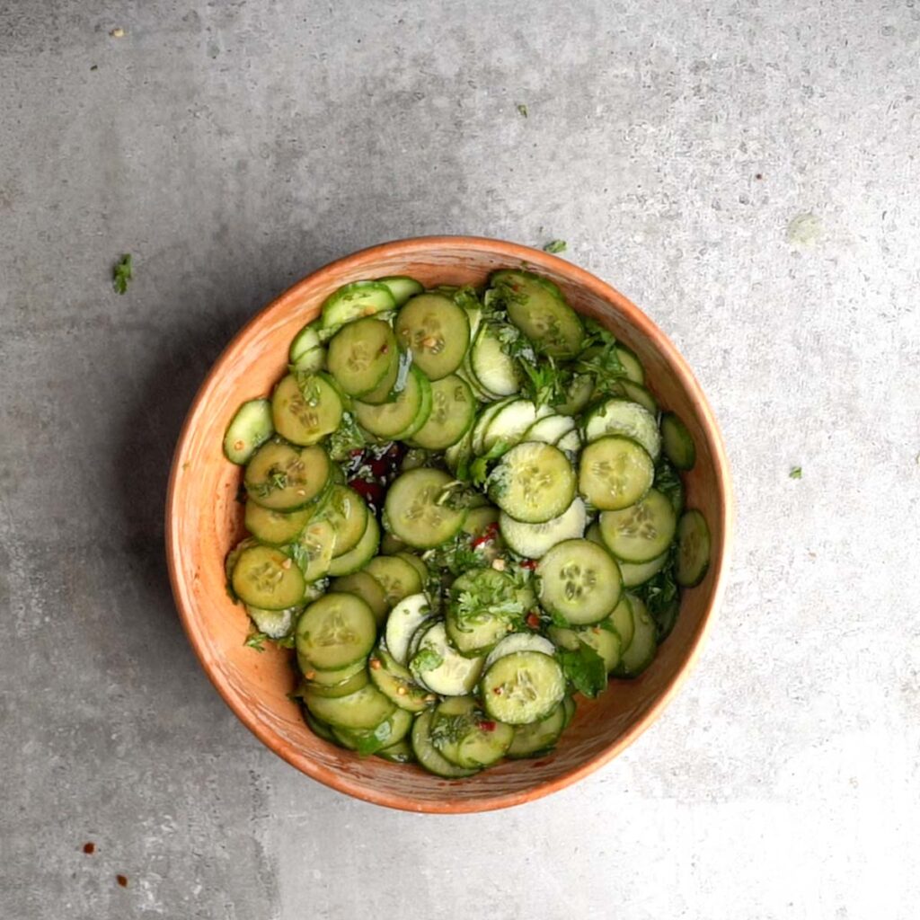 Spicy Asian Cucumber salad mixed in a wooden bowl