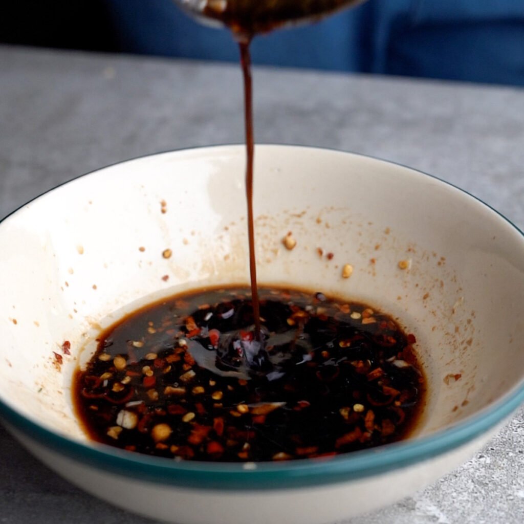 Pouring the Spicy dressing for the spicy cucumber salad