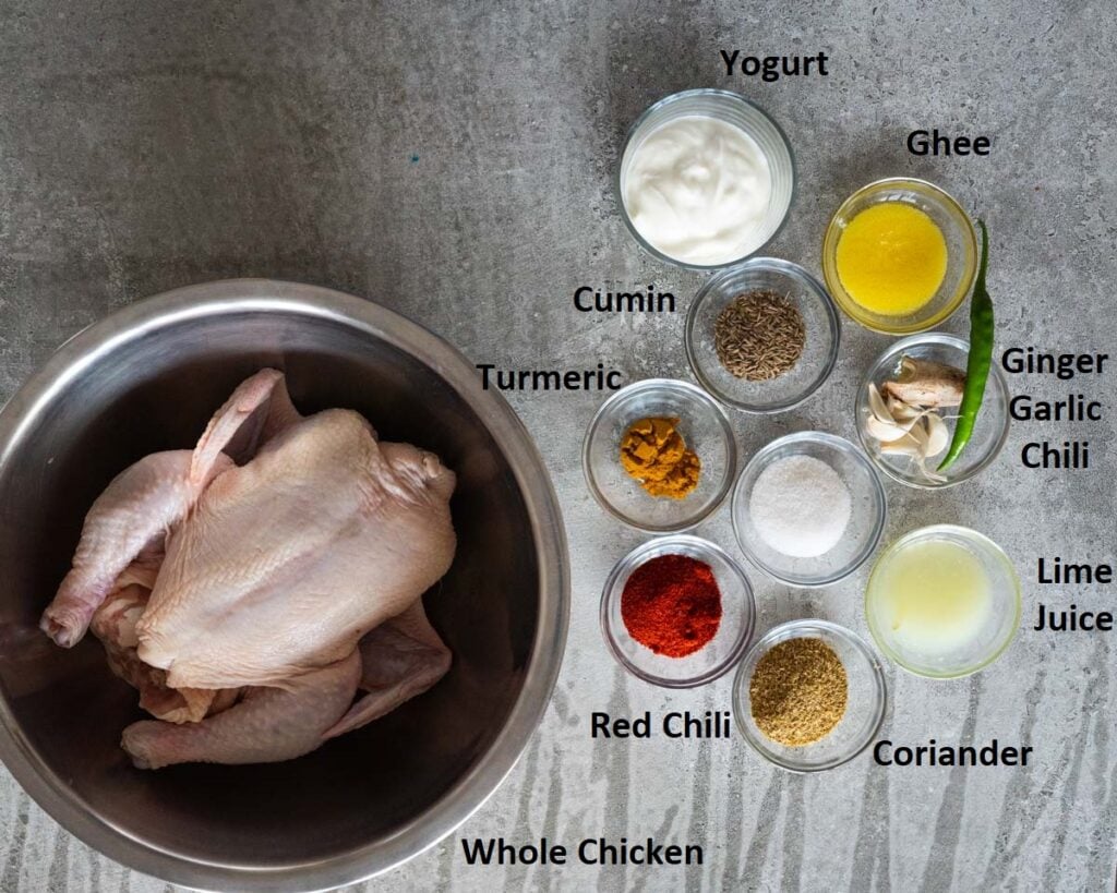 Ingredients needed to make Indian style spiced roast chicken - whole chicken, yogurt, lime juice, salt, turmeric, coriander powder, ginger, garlic, & chili