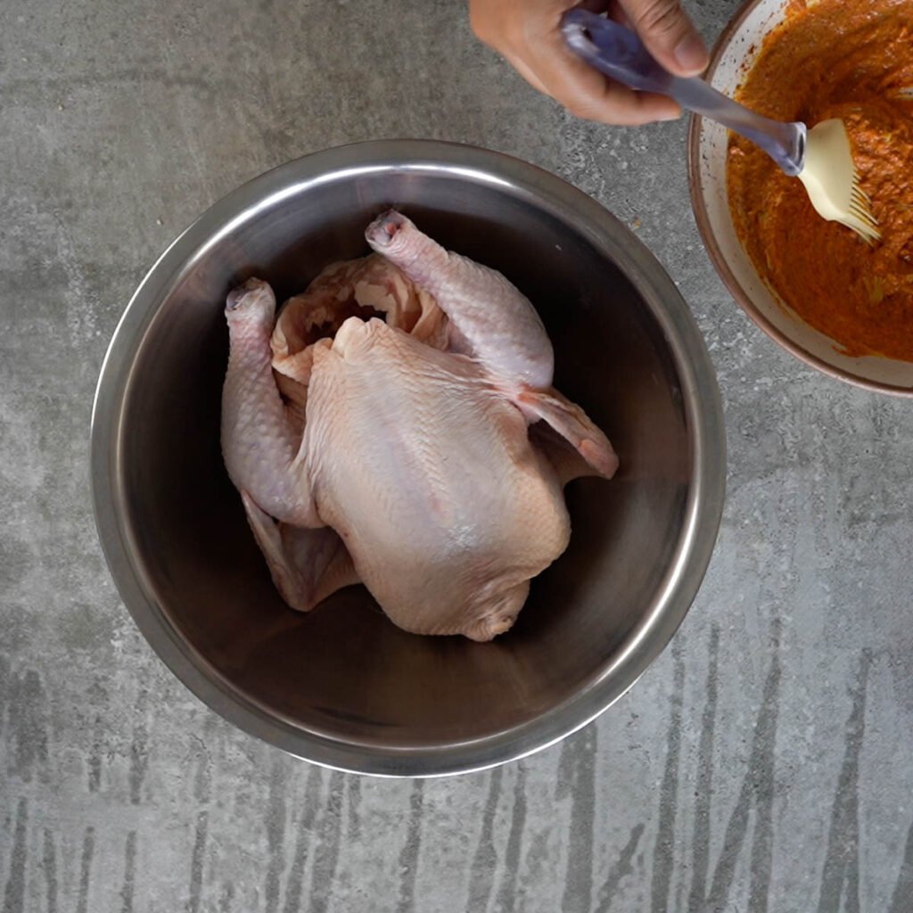 Whole Chicken being marinated