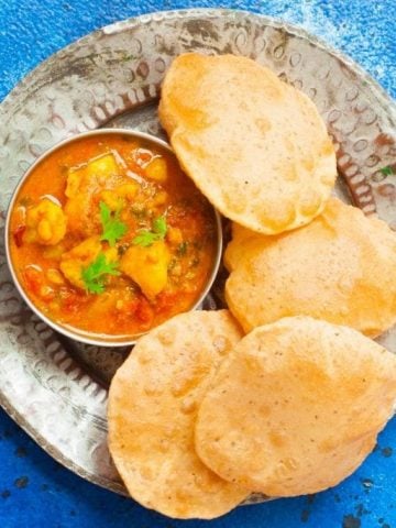 Aloo Tamatar Sabzi - North indian Potato curry made in the pressure cooker,served with Pooris and Kachories during festivals and fasts.