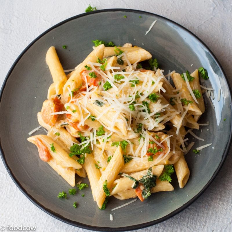 Penne pasta in Creamy Alfredo Sauce with tomatoes and Basil