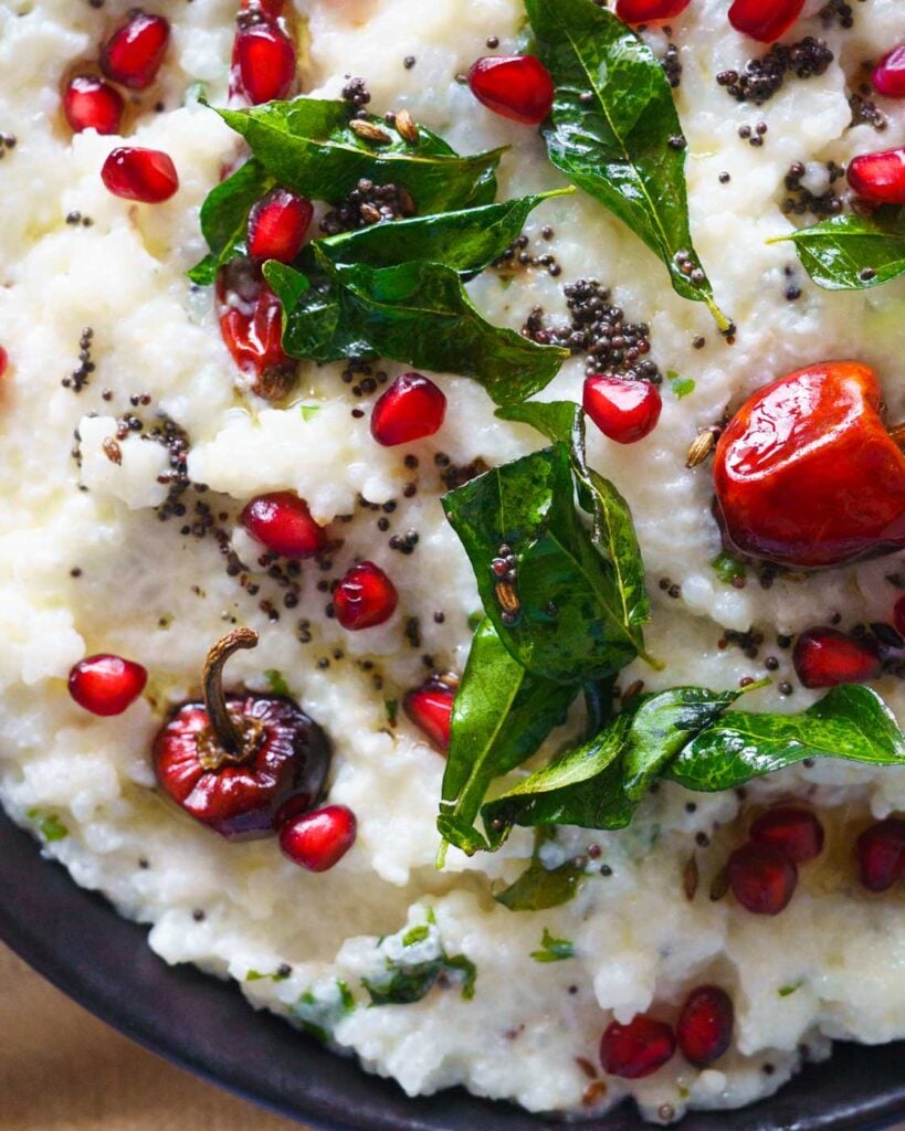 Curd Rice with pomegranate seeds, tempering of mustard seeds, curry leaves and chilies