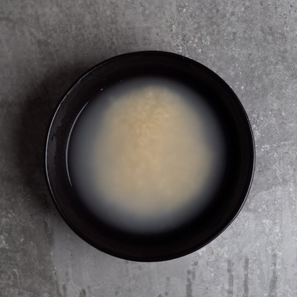 washed rice in a black bowl