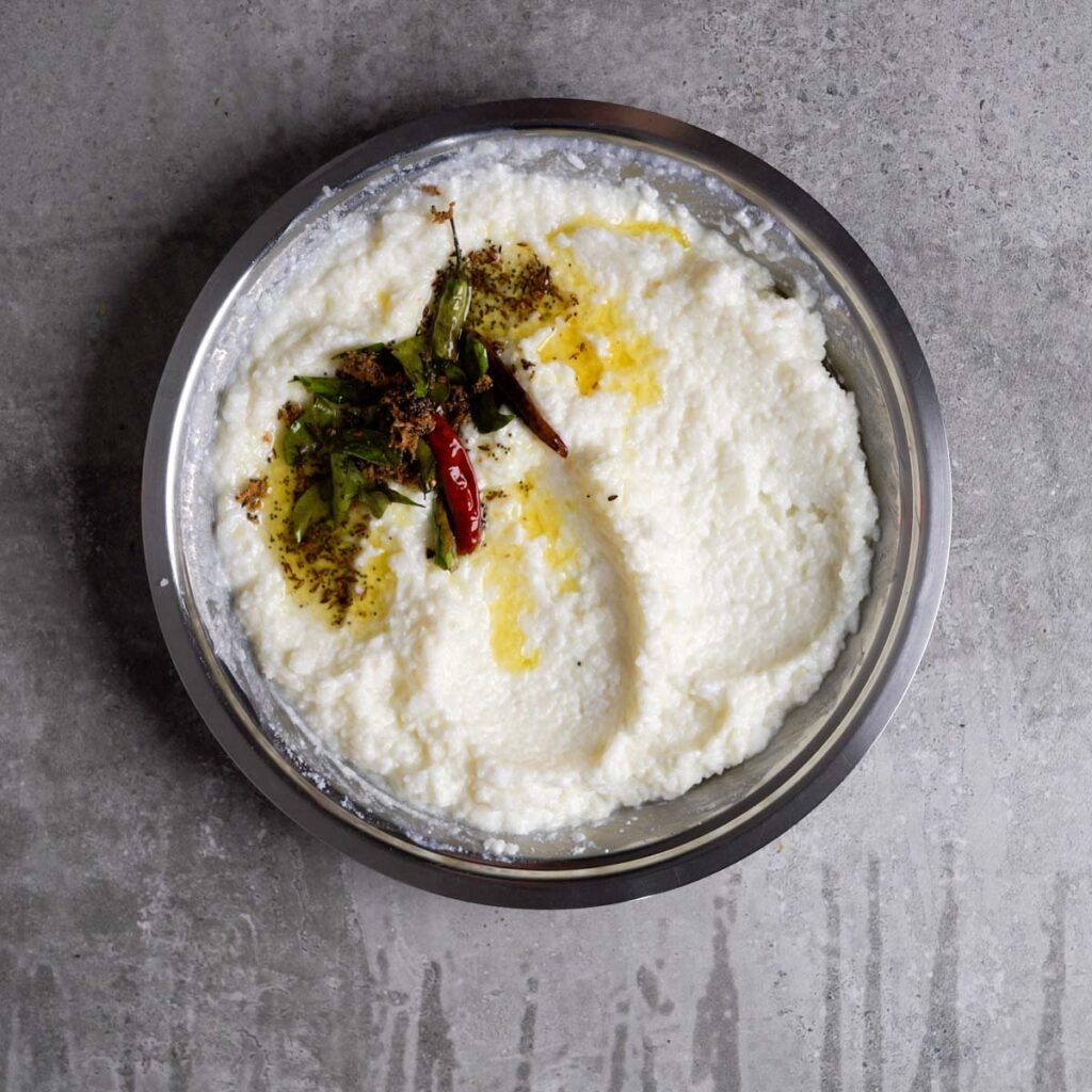 Curd rice with tempering of curry leaves, chilies and mustard seeds