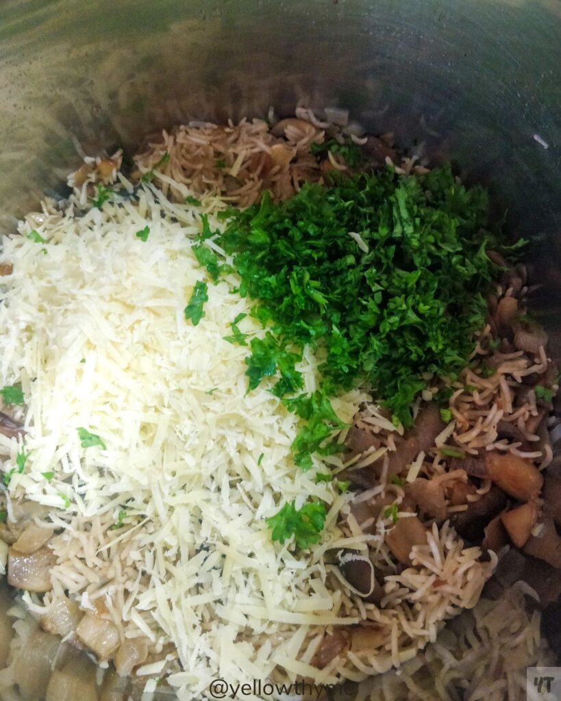Parmesan cheese and parsely on top of cooked mushroom rice