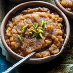 Aate Ka Halwa or Kada Prasad in a bowl with green pistachios on top.
