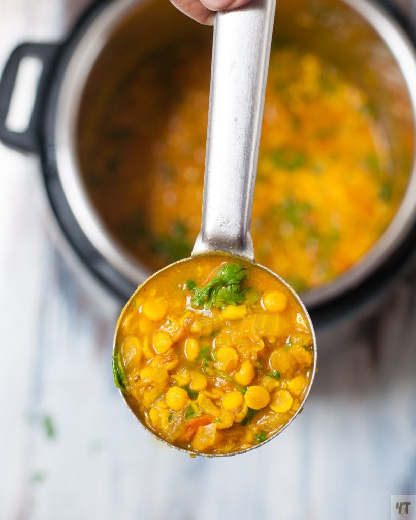 Instant Pot Channa Dal in a large ladle.
