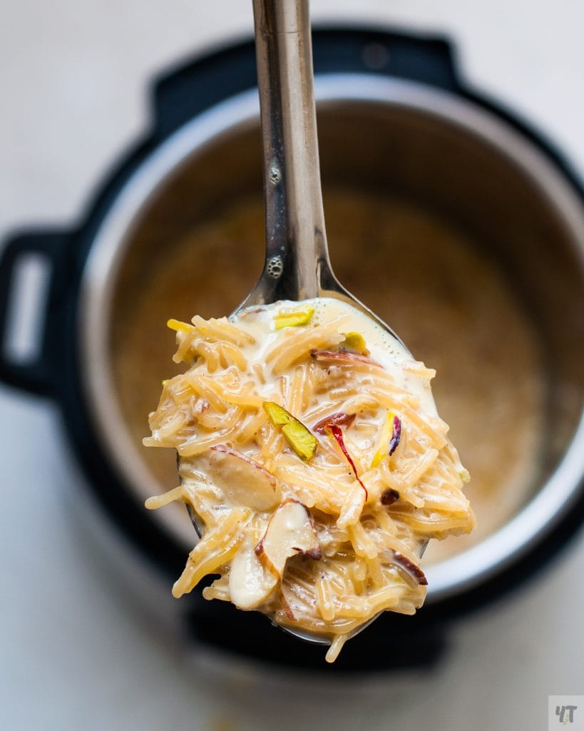 Instant Pot Vermicelli Kheer - Semiya Payasam or Sev ki Kheer on a large spoon with pistachios, almonds and saffron as garnish.