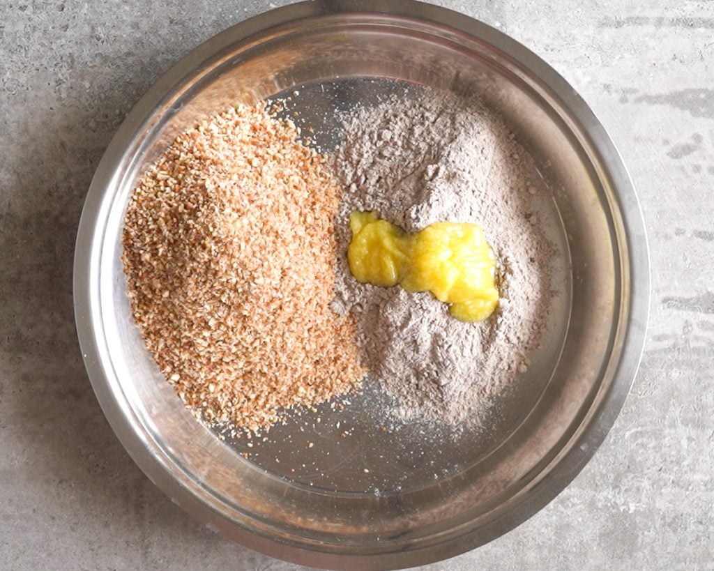 Mixing toasted Ragi, Powdered nuts and ghee