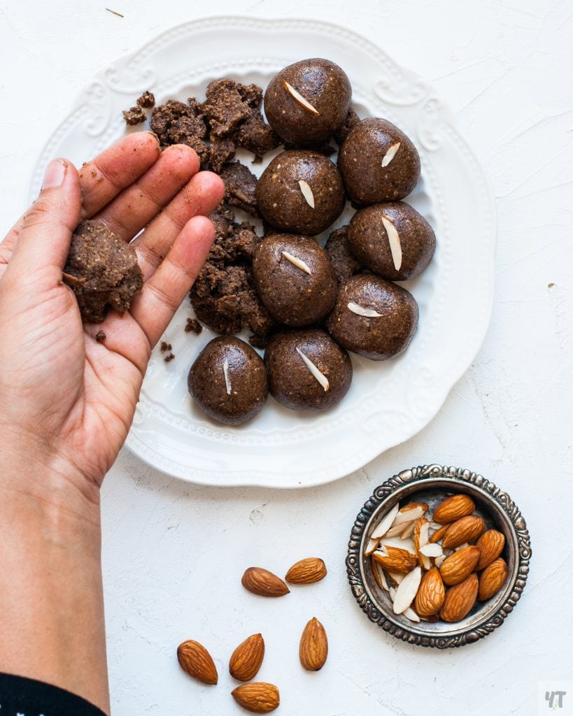 Making of Ragi Laddu - Ragi Laddoo mixture in the hand.