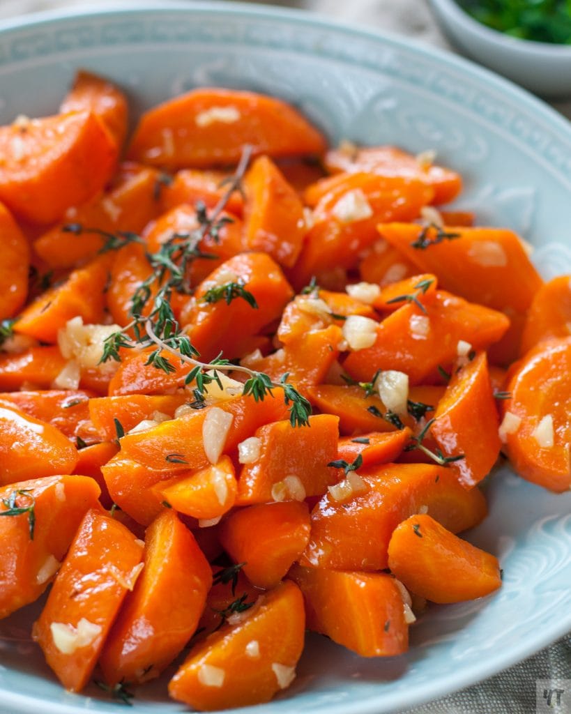 Instant Pot Honey Garlic Glazed Carrots  with thyme in a green bowl