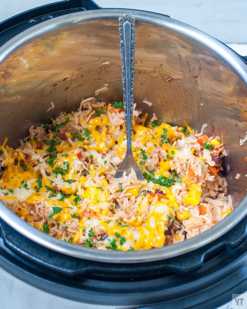 Close up of Instant Pot mexican rice burrito bowl - Cooked rice with salsa, beans, chicken , corn and bell peppers