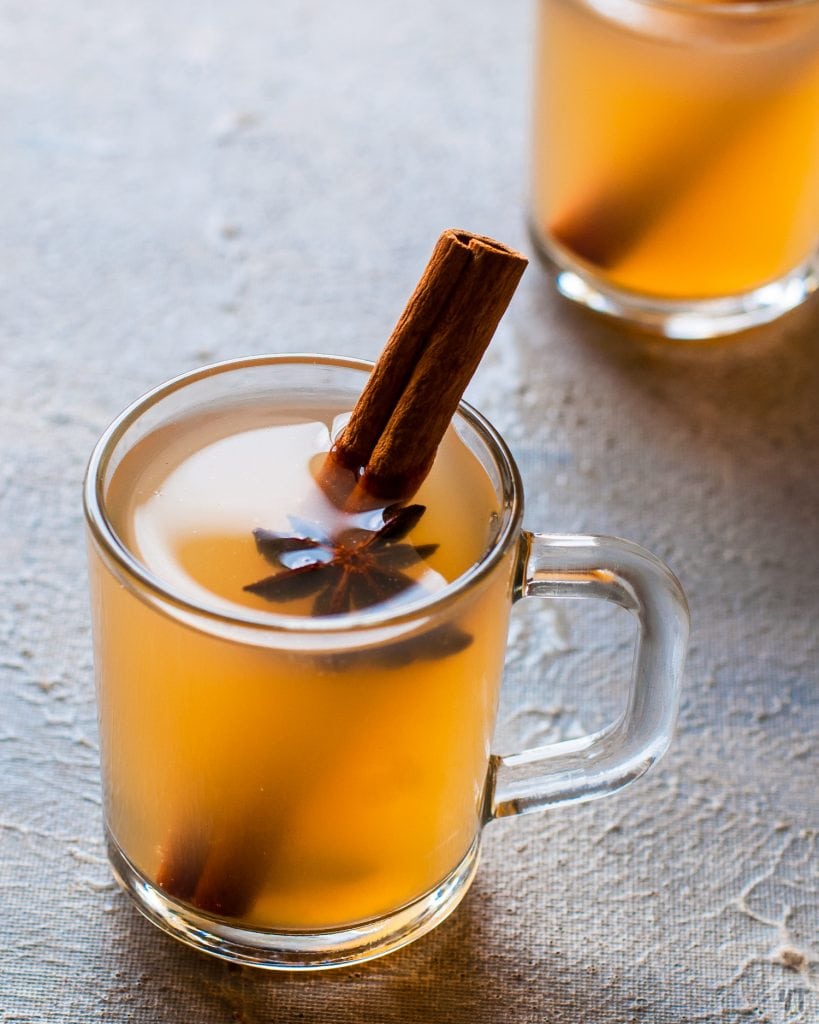 Instant Pot Apple Cider in a Glass cup with star anise and cinnamon