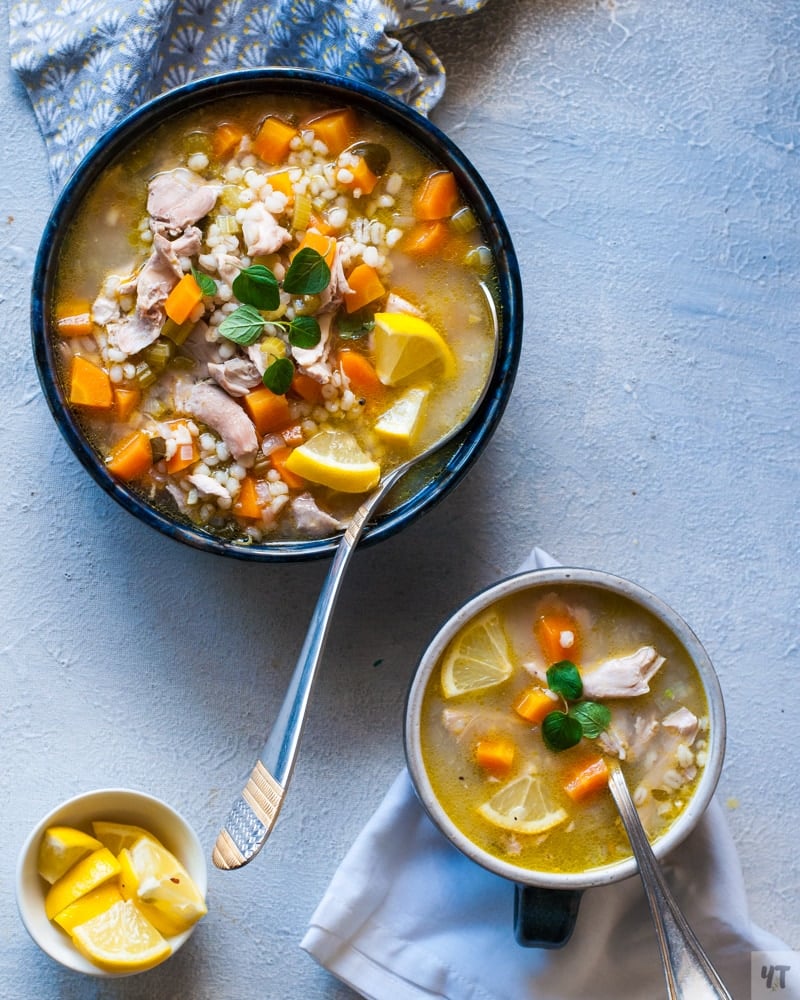 Close up of Instant Pot Chicken Barley Soup in a blue bowl