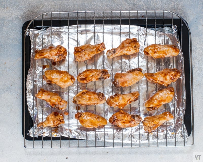 Baking the pressure cooked chicken wings with BBQ sauce