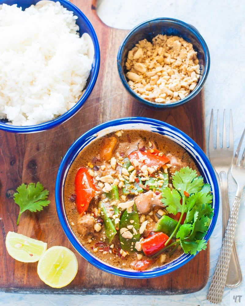 Instant Pot Thai Chicken Curry in a blue bowl with White Rice ,lime and cilantro