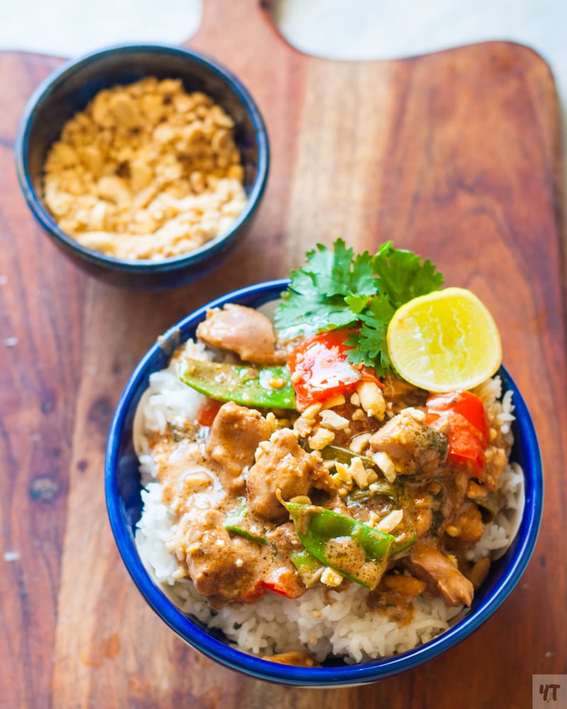 Instant Pot Thai Chicken Curry in a blue bowl with lime and cilantro