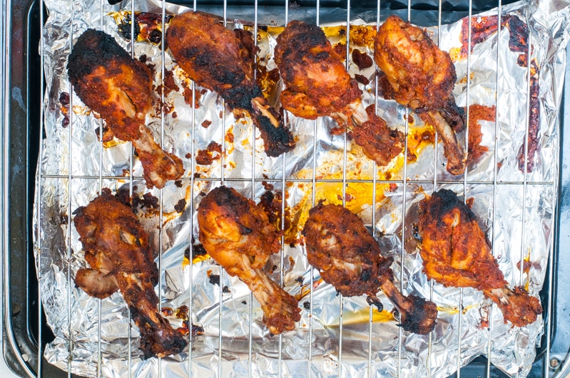Tandoori Chicken drumsticks on a roating tray