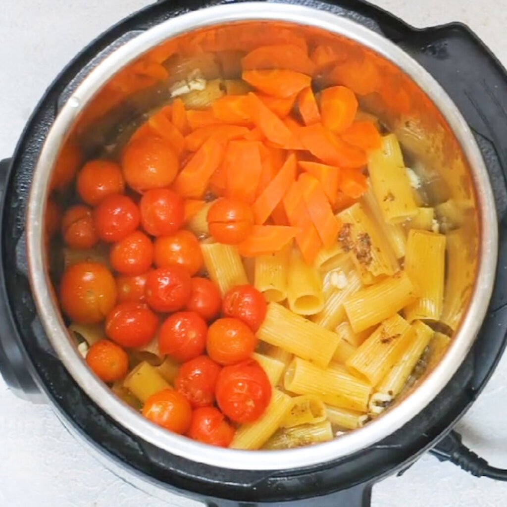 Instant Pot with cooked tomatoes, carrots and pasta