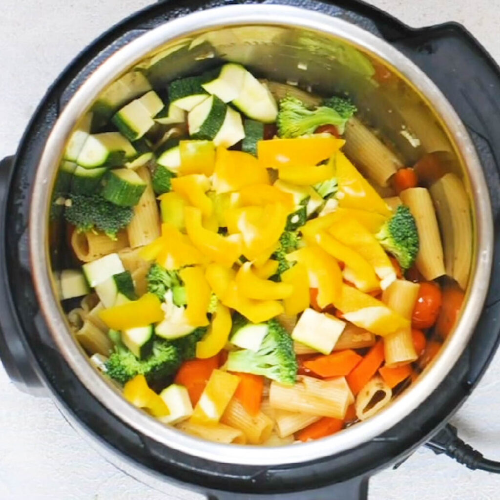 Instant pot full of veggies ready to make instant pot pasta primavera