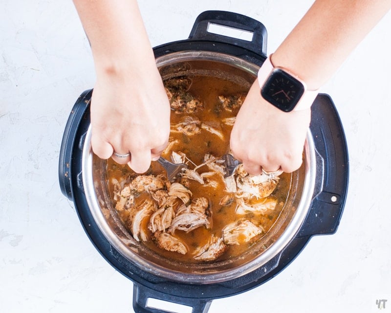 Shredding Instant Pot Chicken Carnitas with forks