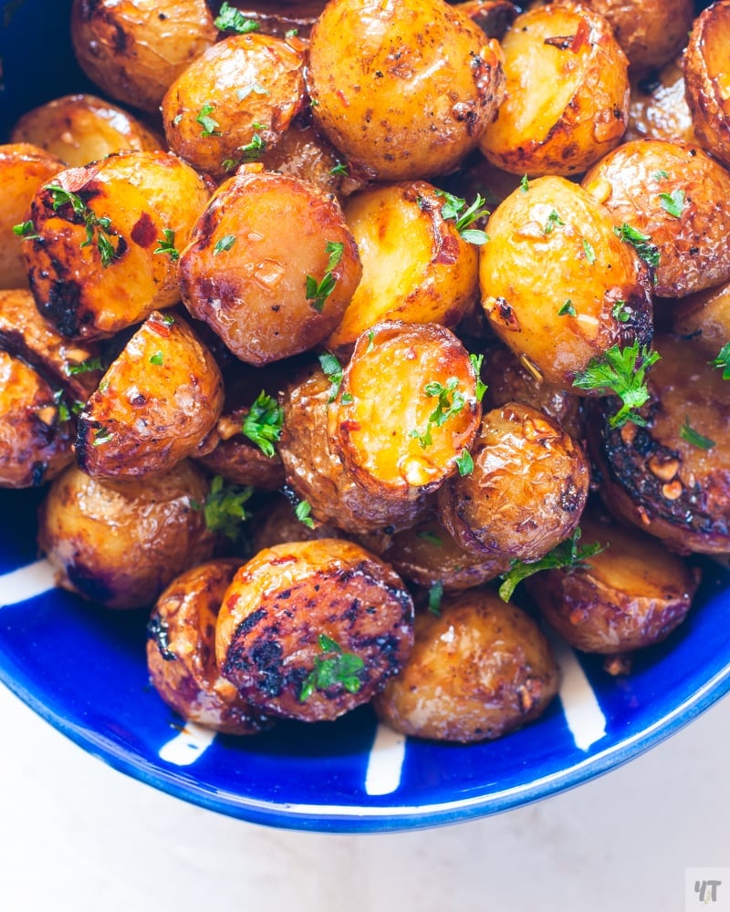 Crispy Honey Garlic Baby Potatoes in a blue bowl