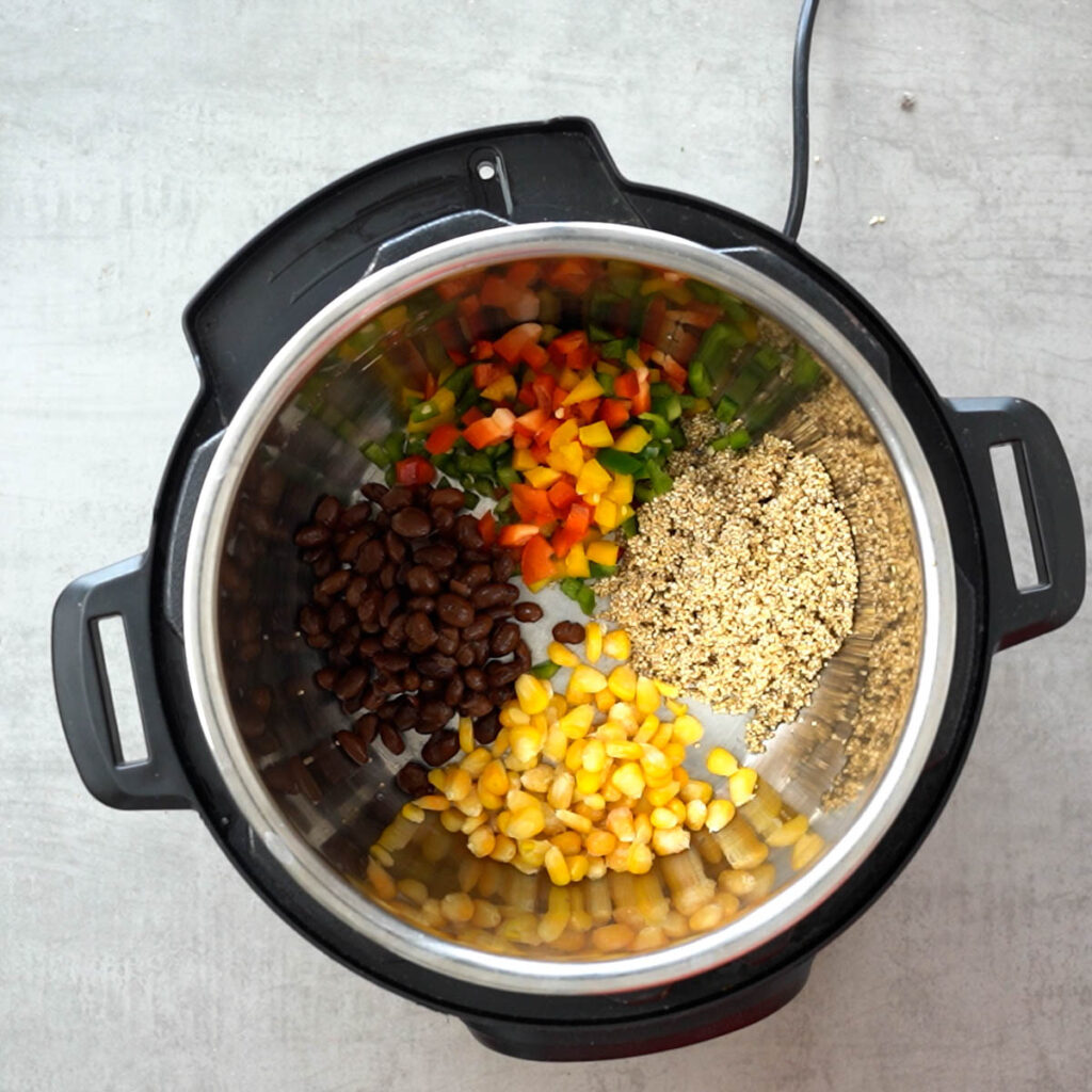 bell peppers, corn, quinoa and beans in instant pot to make instant pot mexican quinoa