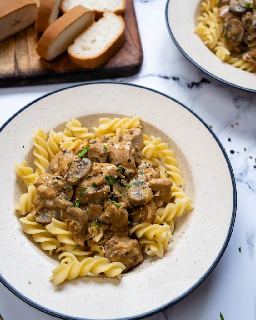 Instant Pot Chicken Stroganoff in a white plate with pasta