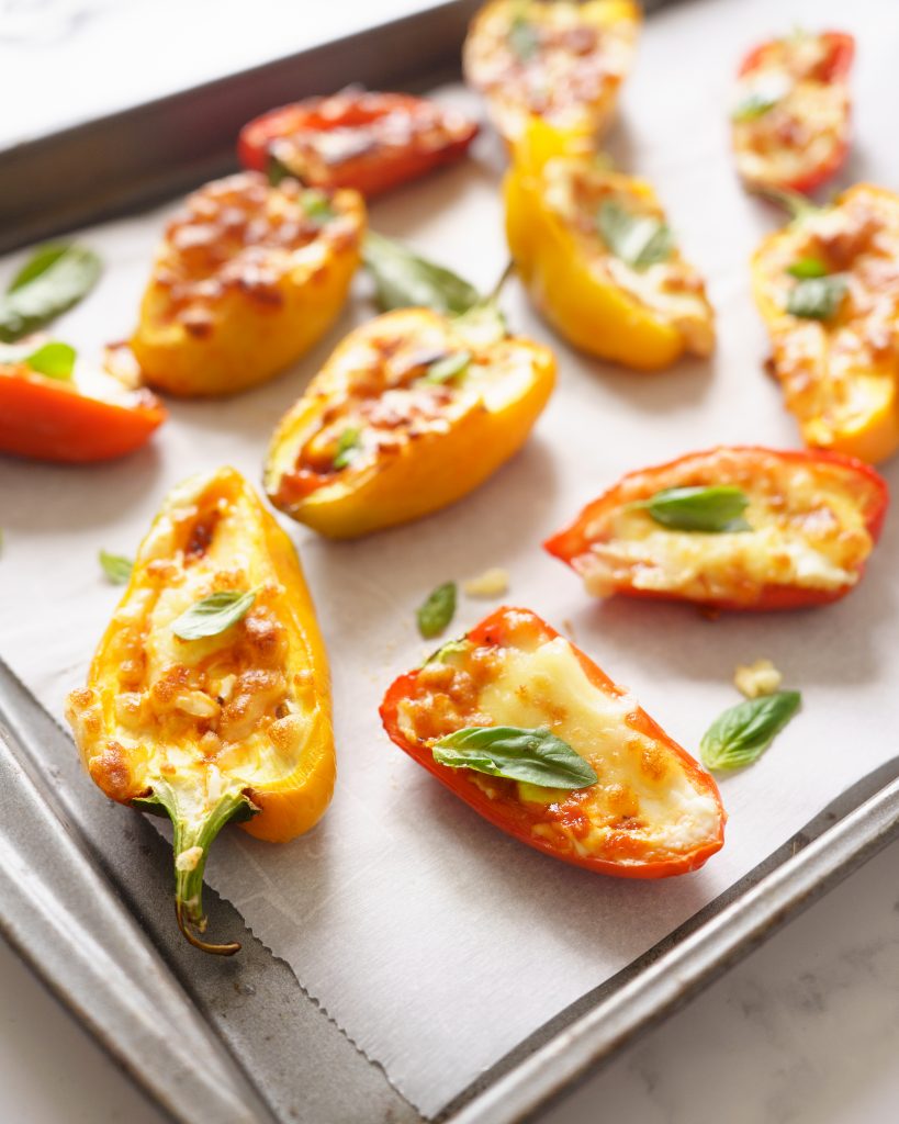 Air Fryer Mini Peppers  with basil leaves on a tray