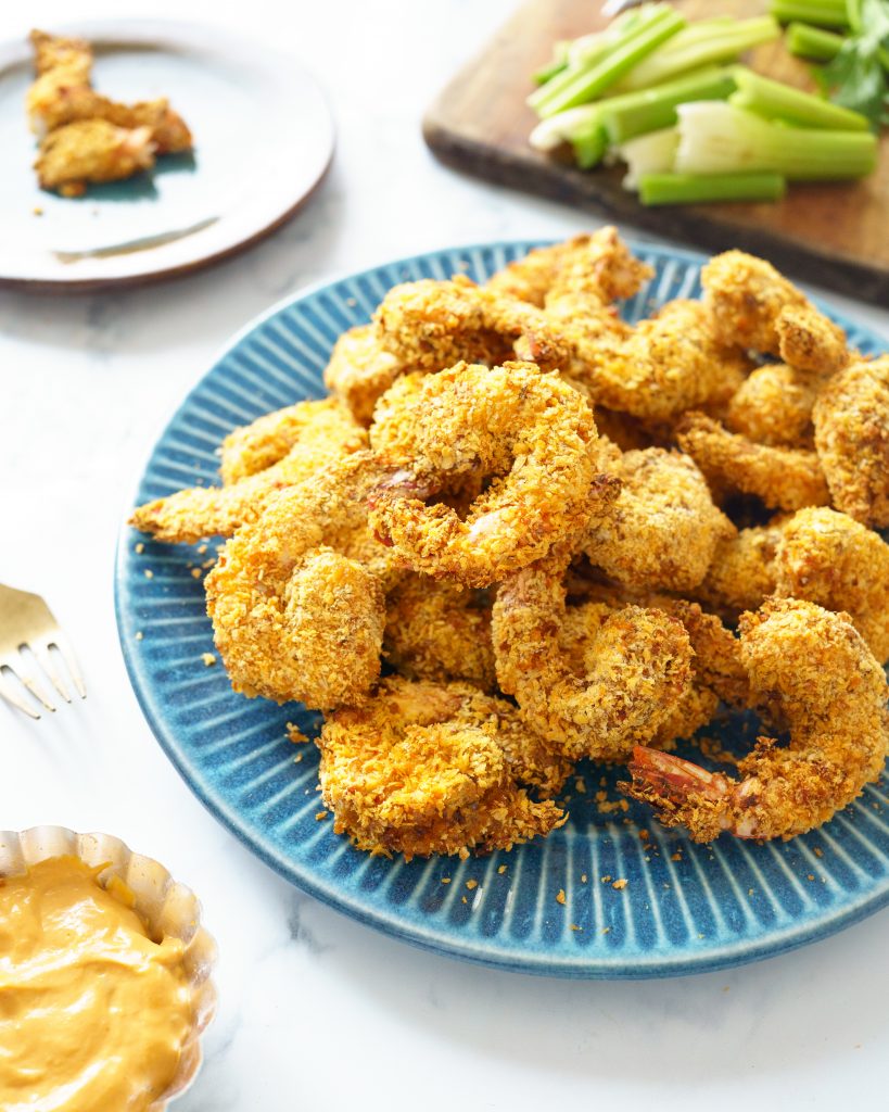 Cooked popcorn shrimp in a blue plate.