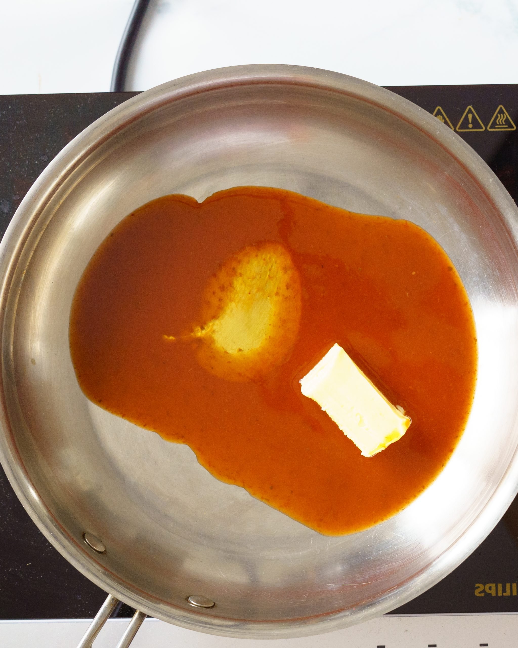 making buffalo sauce with hot sauce, butter and honey