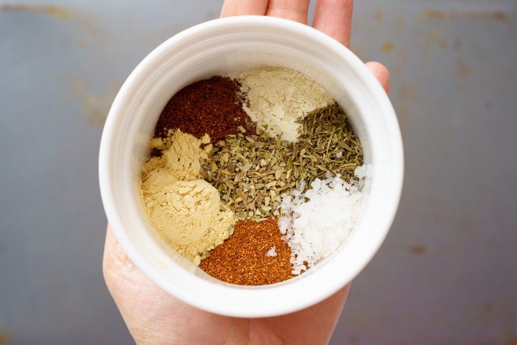 Homemade cajun seasoning in a cup