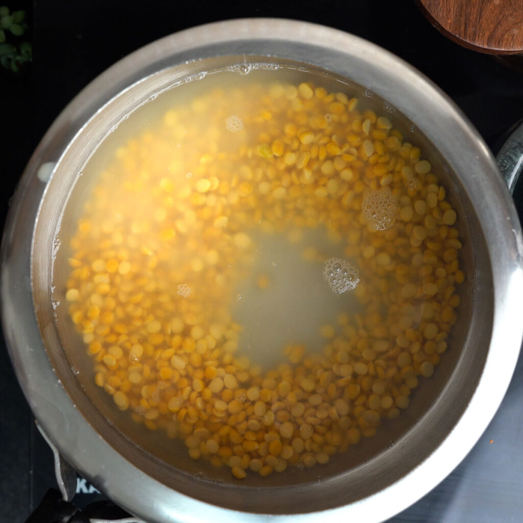 Washed Soaked Chana Dal inside a pressure cooker with water