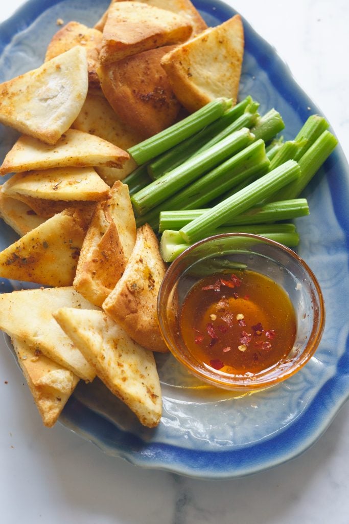 Appetiser platter with pita chips, celery , Honey chilli dip