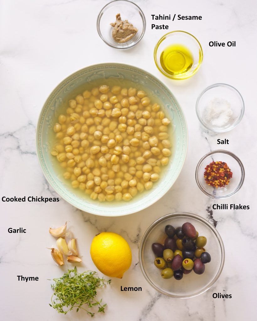 Ingredients to make Hummus with olives
Olives, chilli flakes, salt, olive oil, tahini, cooked chickpeas, garlic, thyme and a lemon