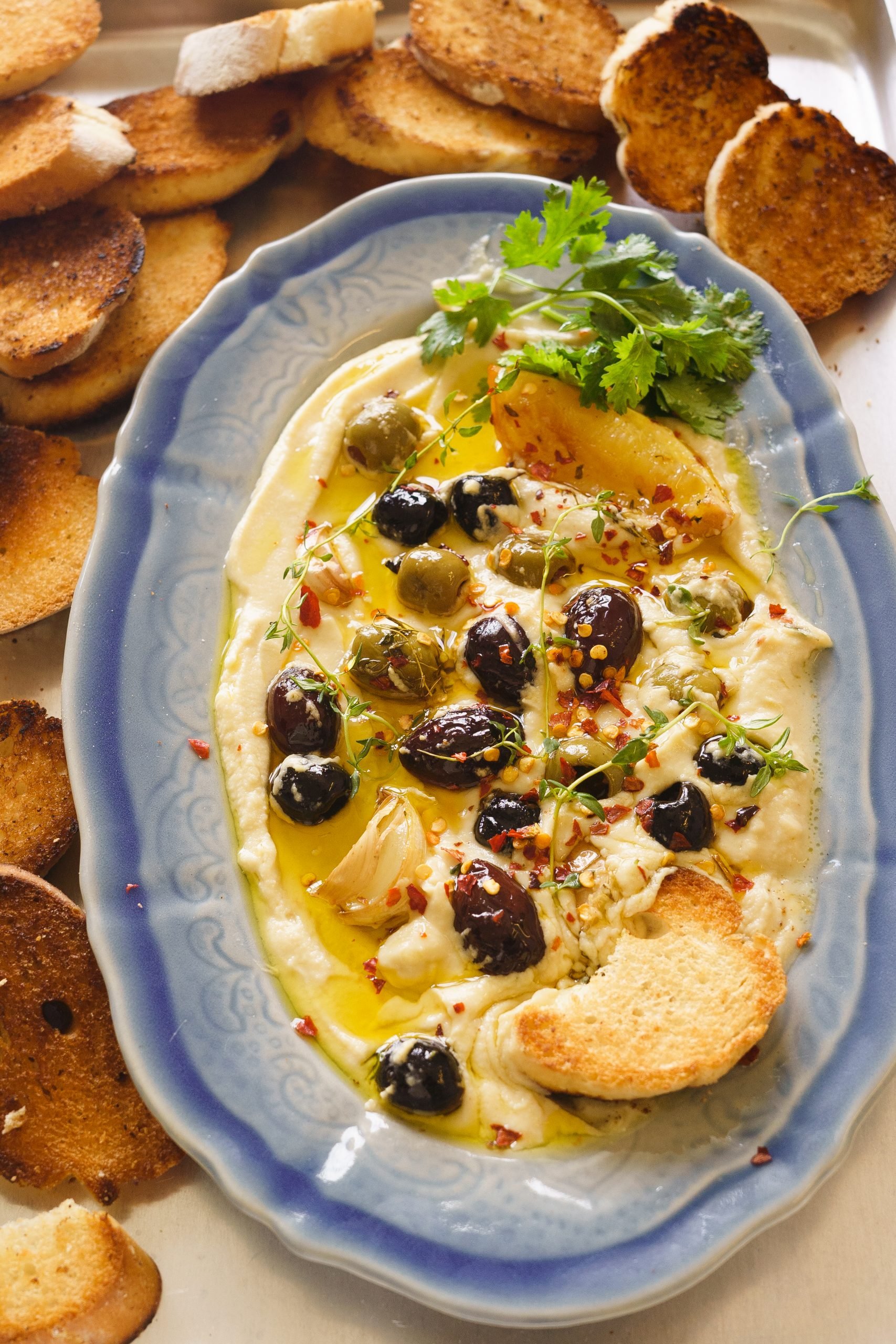 Hummus with Roasted Olives , Garlic , Lemon and Herbs